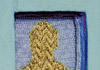 <strong>Grave of an Arctic Starflower</strong>, 2008<br />
<em>Size:</em>6,7 x 24,1 x 4 cm<br />
<em>Technique:</em> hand embroidery<br />	
<em>Material:</em>silk, pearls, metal yarn, painted wood