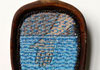 <strong>Water</strong>, 2013<br />
<em>Size:</em> 9,3 x 7,2 x 1,5 cm<br />
<em>Technique:</em> hand embroidery, mixed media<br />	
<em>Material:</em> silk threads, pearls, tarred wood